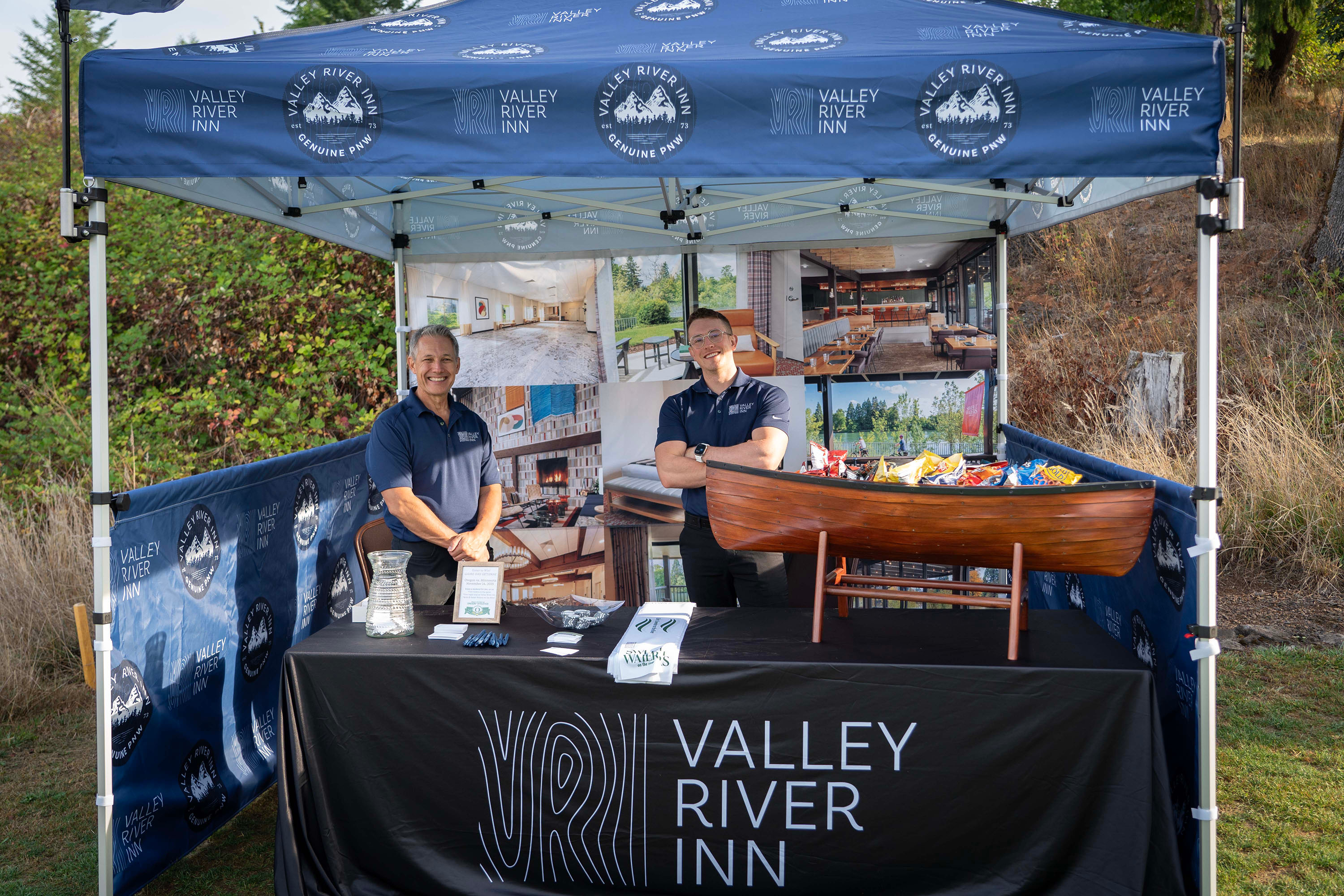 Bushnell University sponsor booth for local business Valley River Inn with snacks and two attendants.