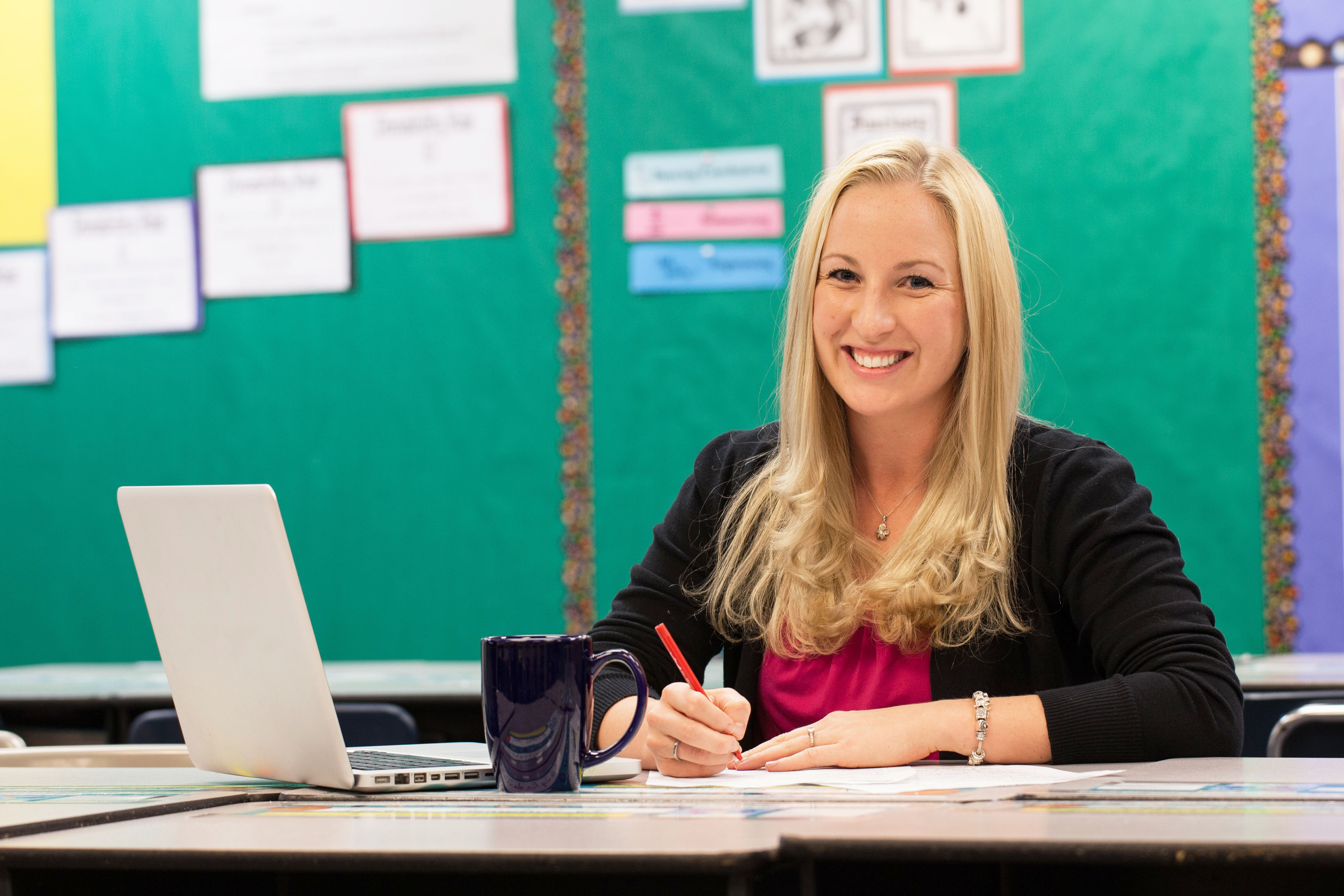 A graduate student studies for their master's degree while working their job as school teacher.