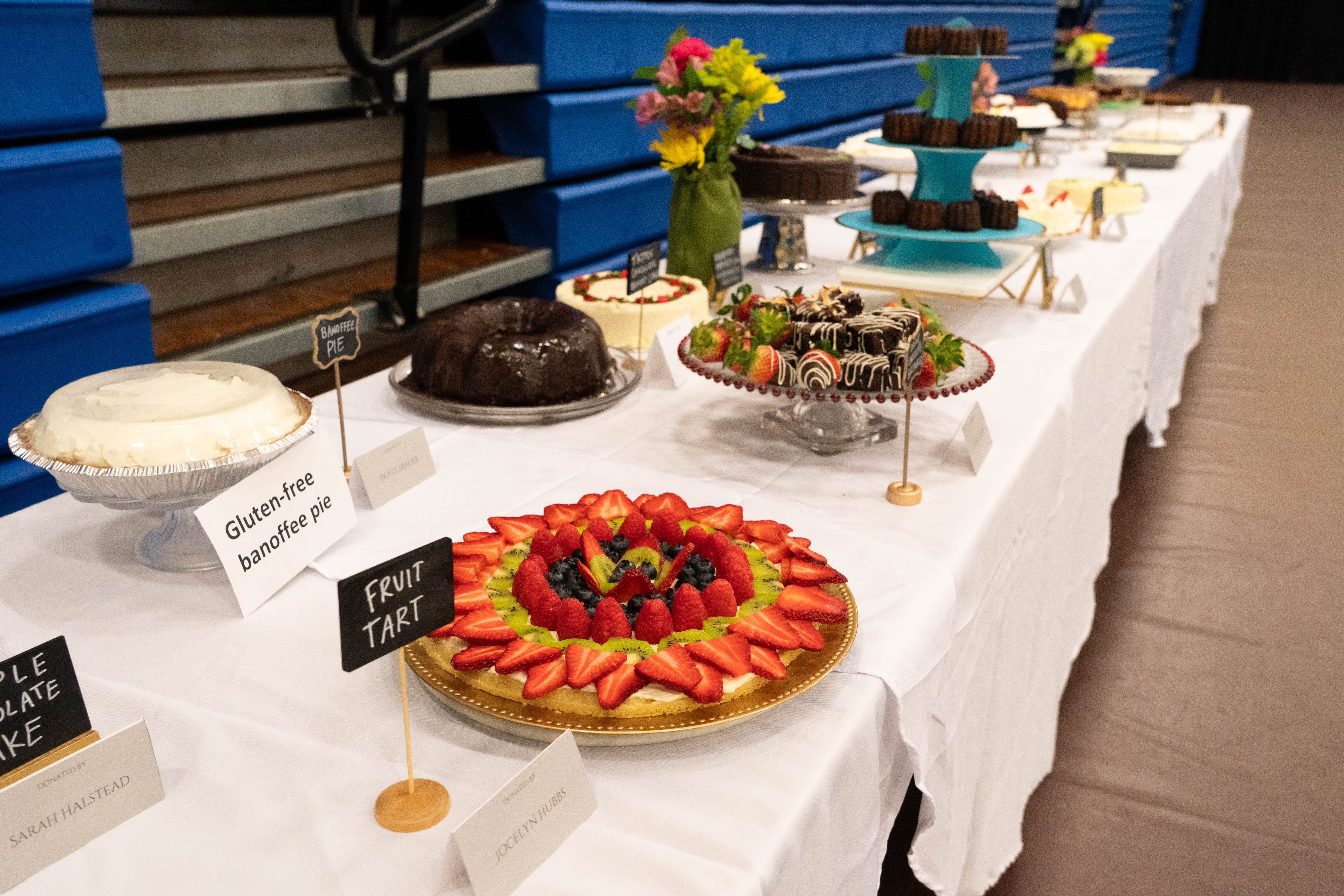 Bushnell dessert auction table with colorful cakes and pastries.