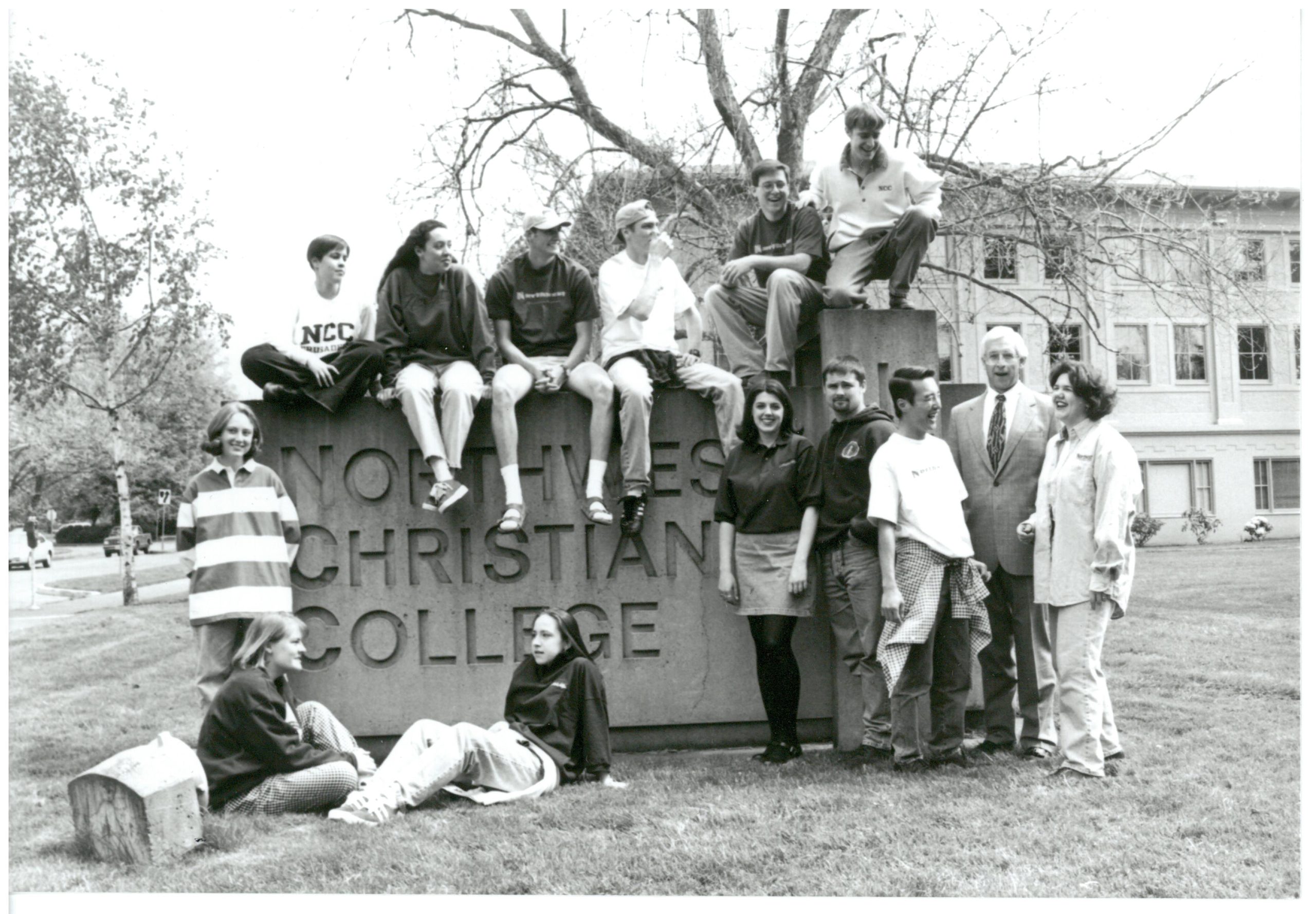 Monument sign of Northwest Christian College surrounded by students and President Jim Womack from 1992.