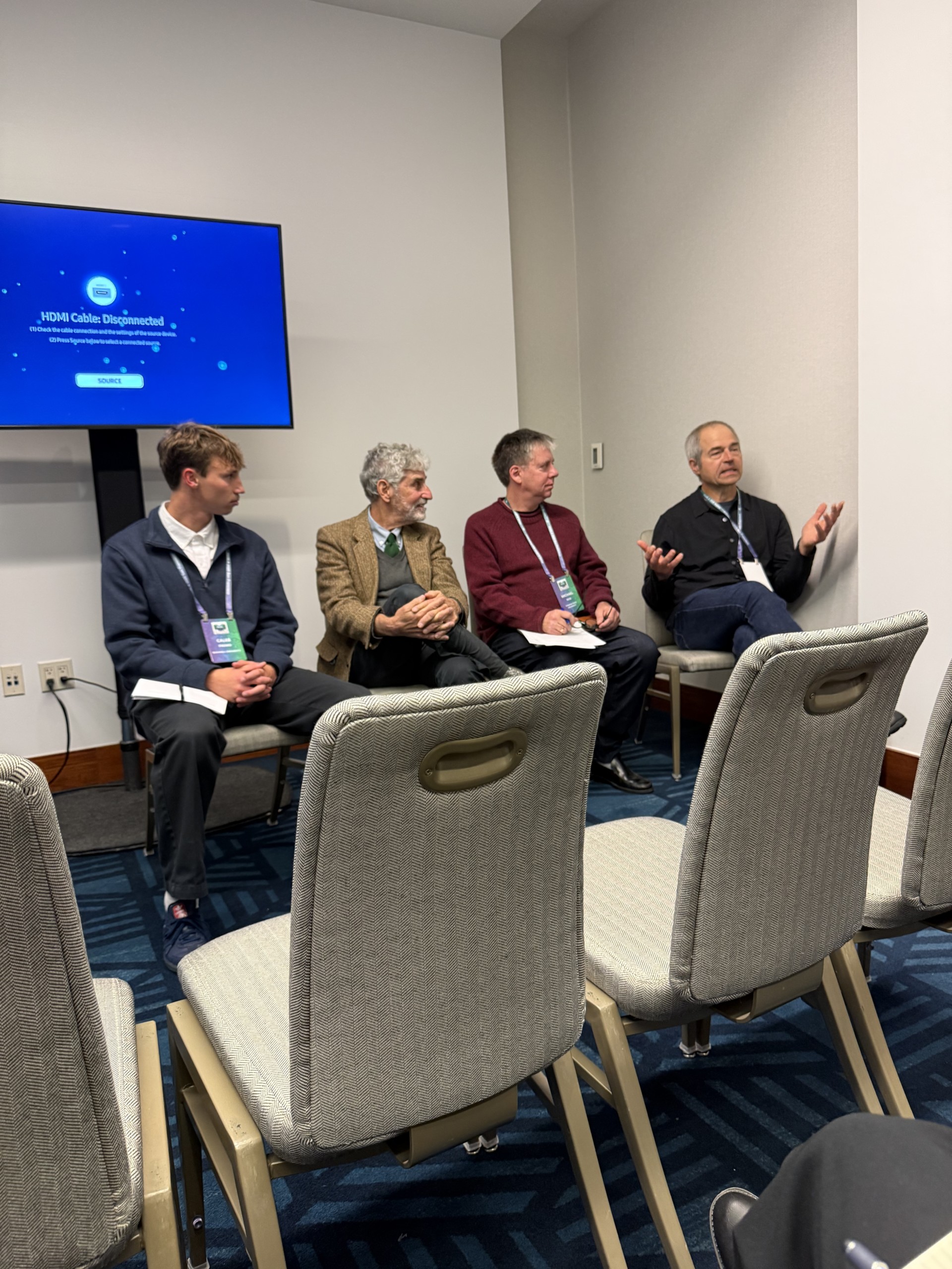 Panelists participate in an academic discussion during a conference session.