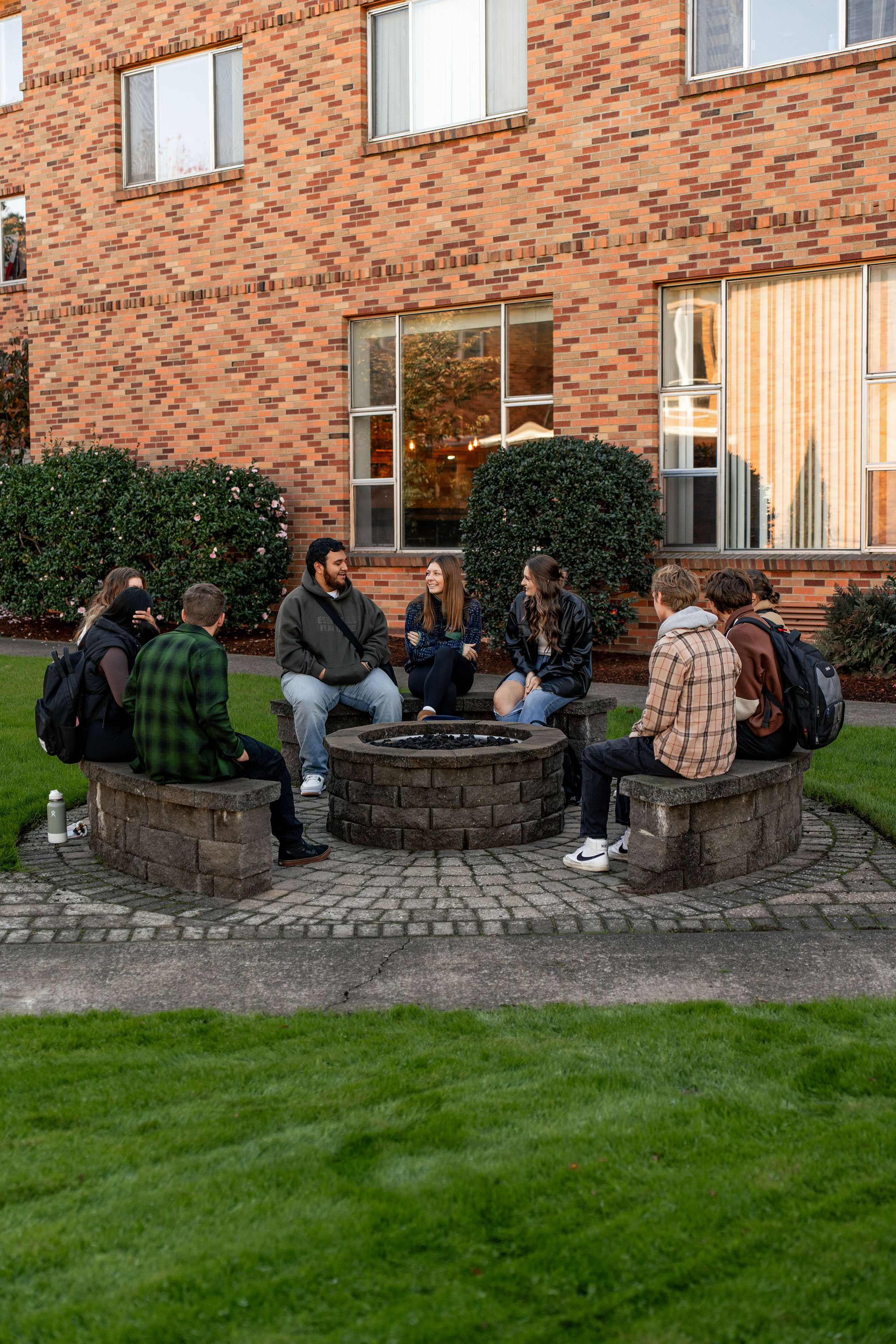 Bushnell bible study small group meeting outside around a fire pit.