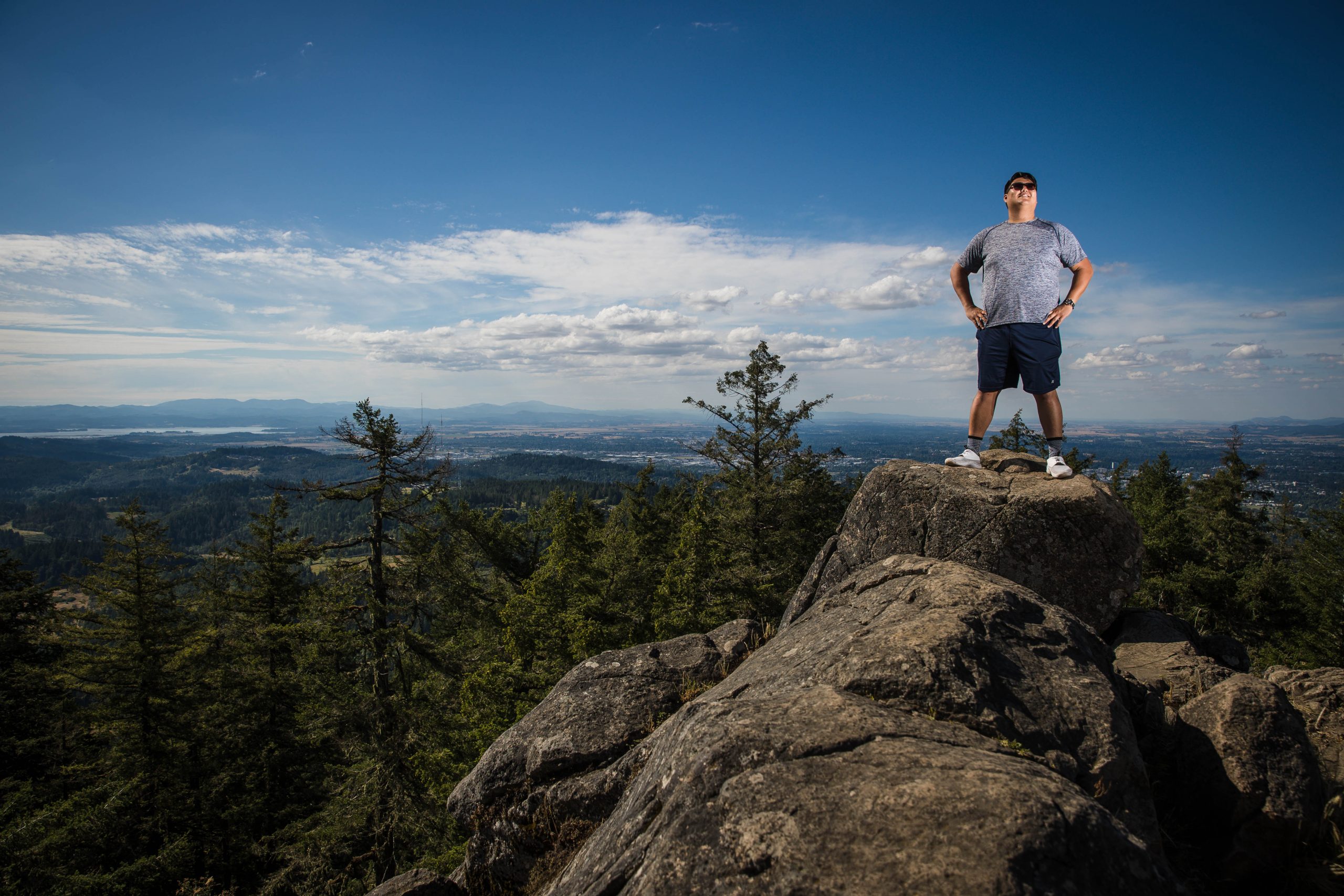 Hiker enjoying the view from the summit of Spencer Butte in Eugene, Oregon.