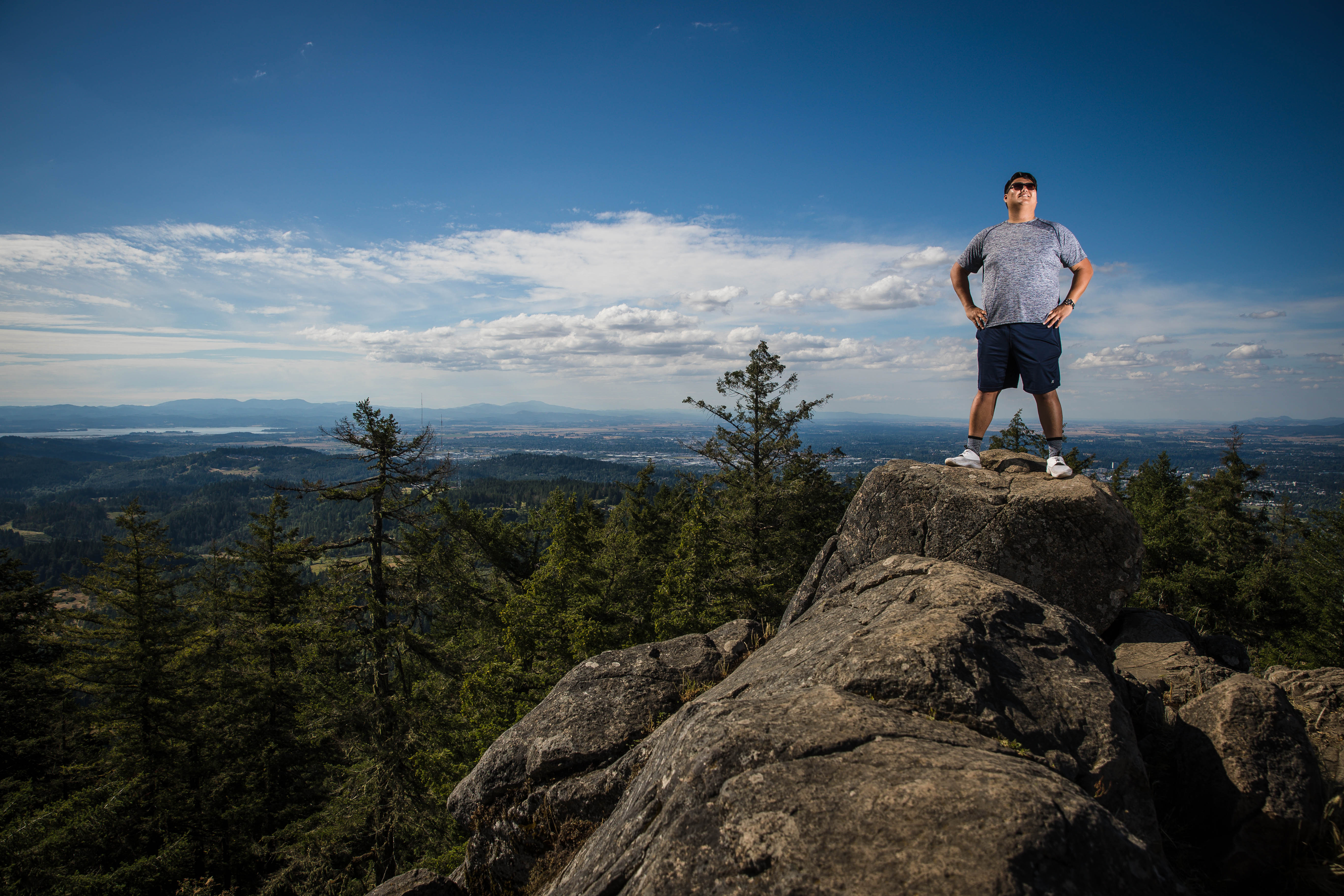 Hiker enjoying the view from the summit of Spencer Butte in Eugene, Oregon.