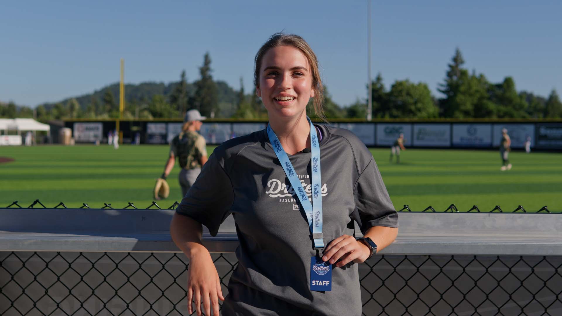 Bushnell University student smiles while working a summer internship with the Springfield Drifters baseball organization.