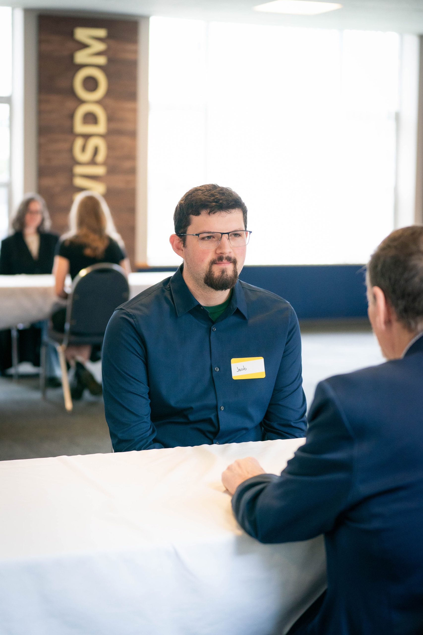 A student talks with a professional during a practice interview.