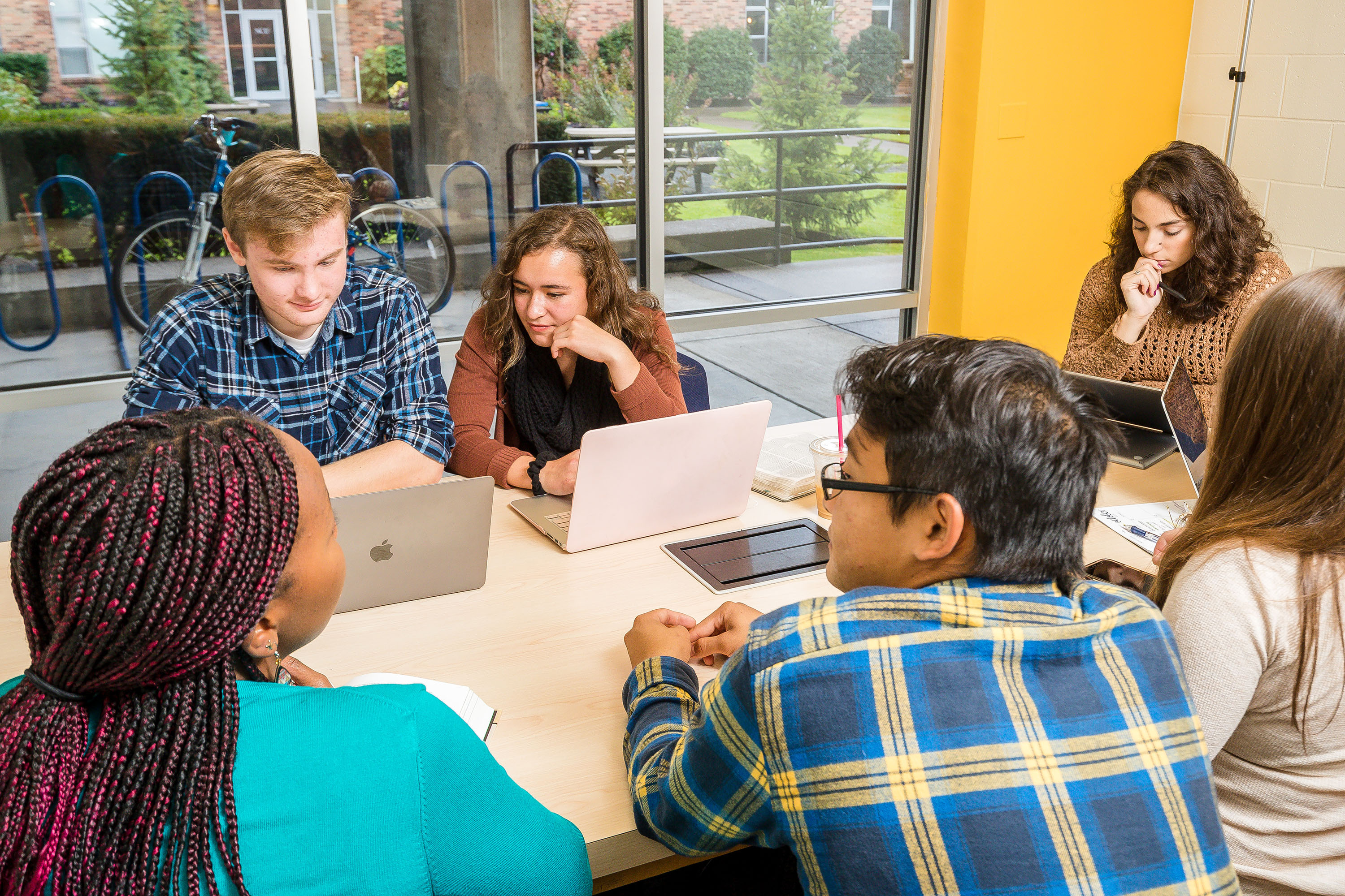 A group of students working in a study group on their computers.
