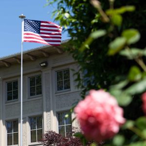 American flag flying on Bushnell University's campus.