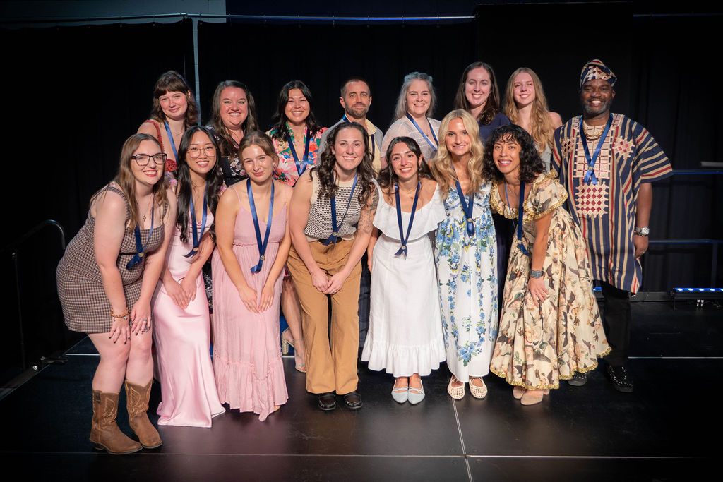 Bushnell University students and faculty gather for a group photo during an awards ceremony.