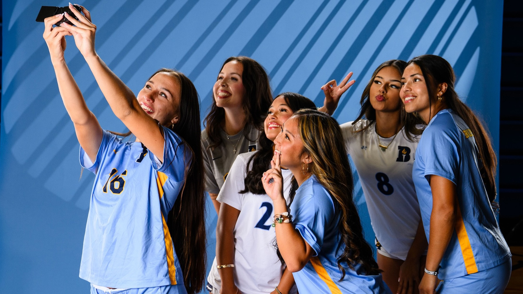 women's soccer players taking a selfie during media day