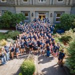 Bushnell University students gather for a group photo outside Goodrich Hall during New Student Orientation.