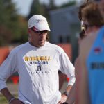 Bushnell track and field coach speaks with student-athletes during an outdoor practice.