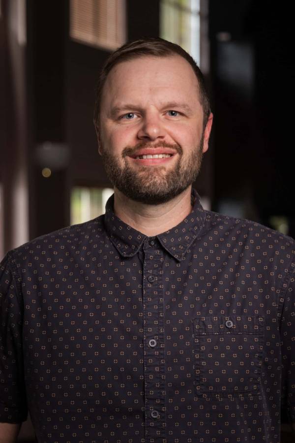 Headshot of male professor in studio