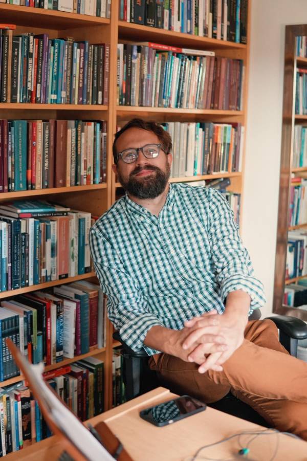 A male professor sitting in office