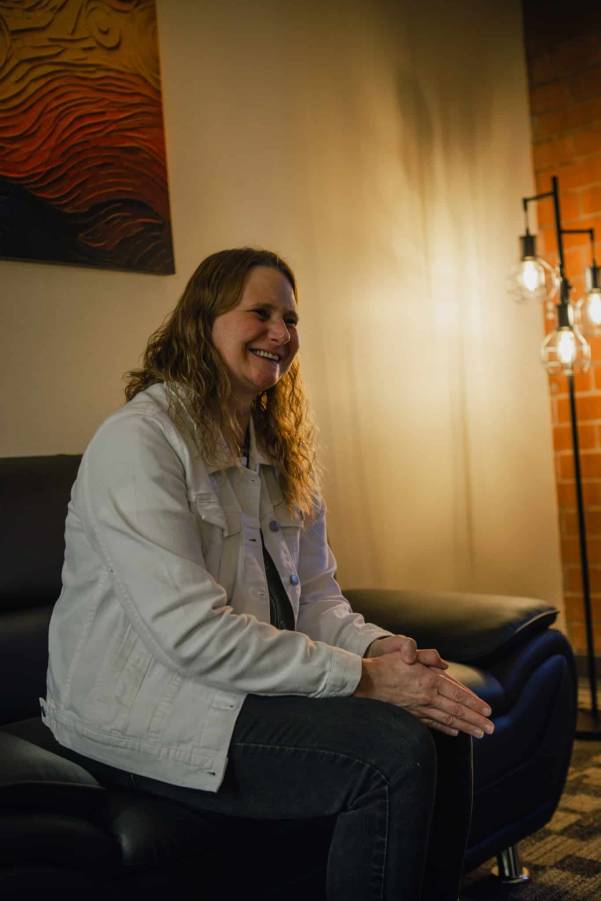 A female sitting on a couch in a counseling setting