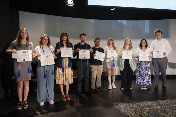 Group of students holding up certificates