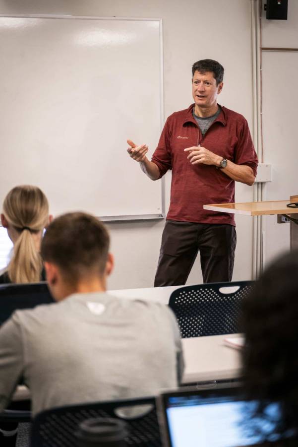 male small business owner speaking to class